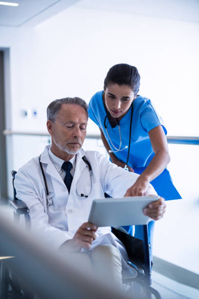 istock Doctor and nurse discussing over digital tablet 649178740