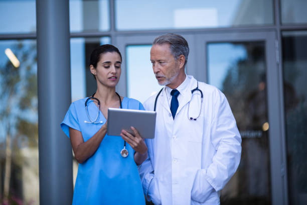 istock Doctor and nurse discussing over digital tablet 649179380