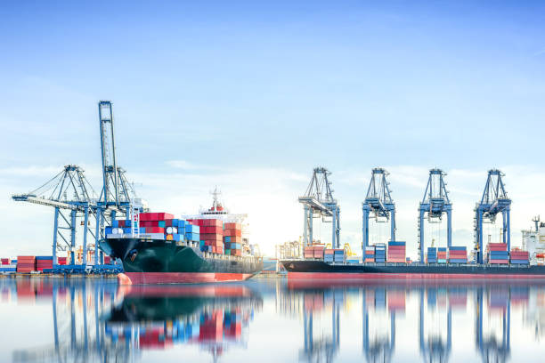 istock International Container Cargo ship with working crane bridge in shipyard background, logistic import export background and transport industry. 649179636