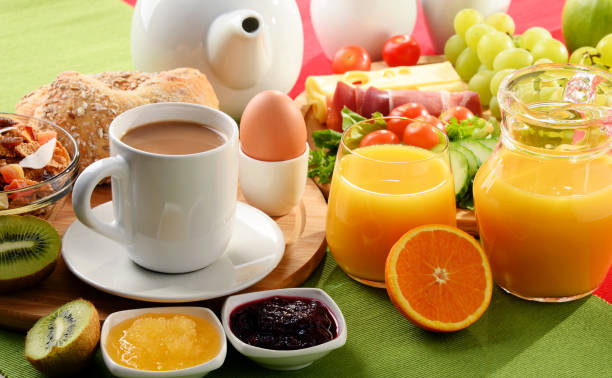istock Breakfast served with coffee, orange juice, egg and fruits 649182982