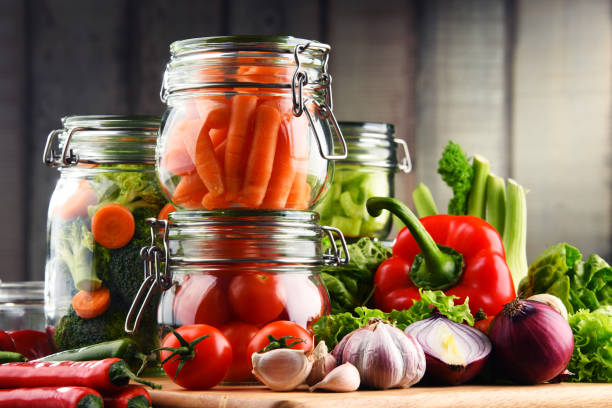 istock Jars with marinated food and raw vegetables on cutting board 649183536