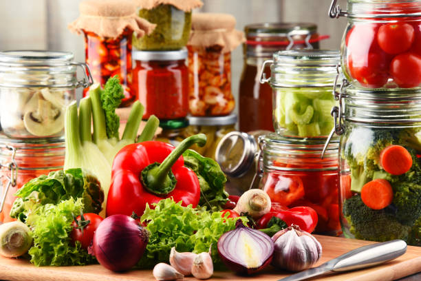istock Jars with marinated food and raw vegetables on cutting board 649183766