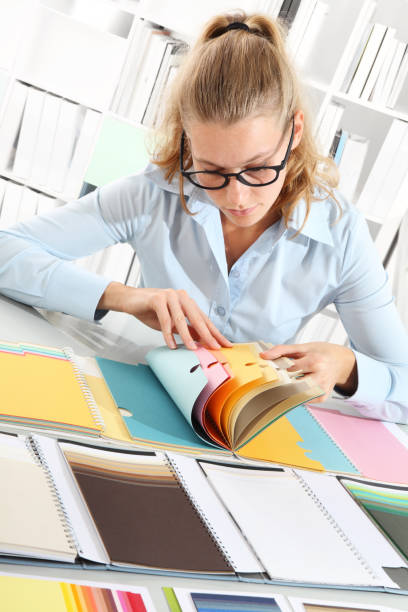 istock woman choosing color with a colors swatch 649184292