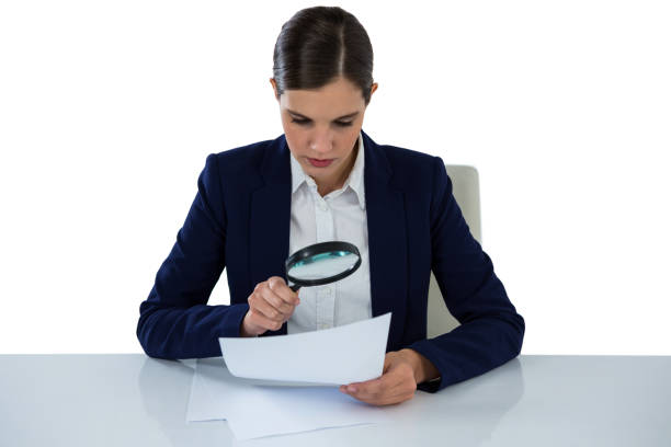 istock Businesswoman looking at document through magnifying glass 649184532