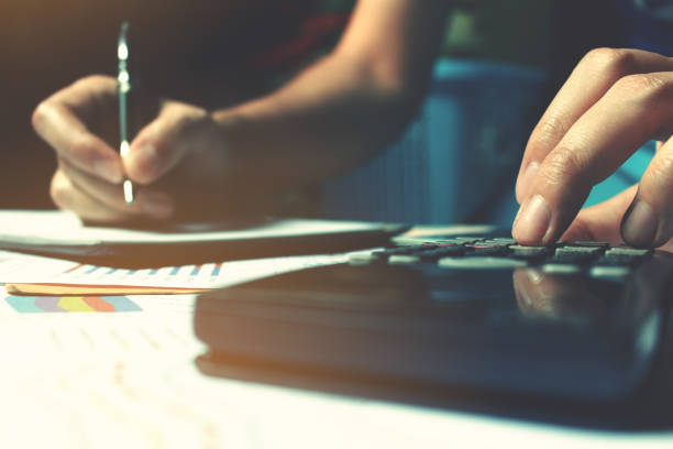 istock Calculator with woman hand calculate about expense on desk. 649188974