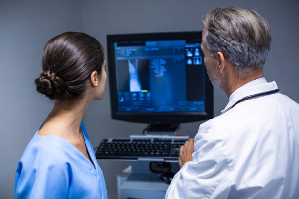 istock Doctor and nurse examining x-ray on computer 649191978