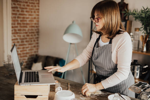 istock Woman in using laptop from domestic kitchen 649192068