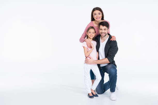 istock Happy young family with one child hugging on white 649192434