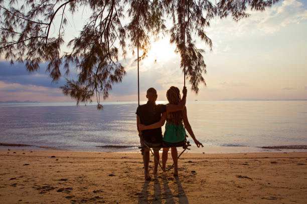 istock Couple  on a swing against  of  sunset 649195206