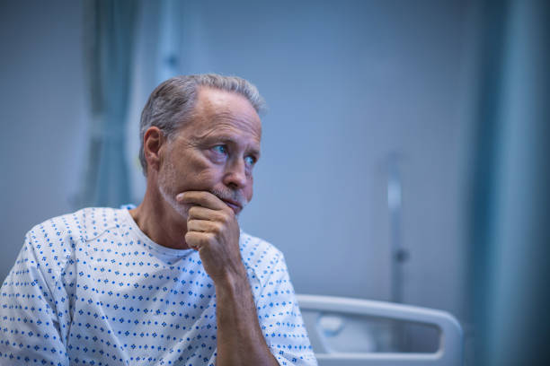 Sick patient sitting on bed Sick patient sitting on bed at hospital hospital depression sadness bed stock pictures, royalty-free photos & images