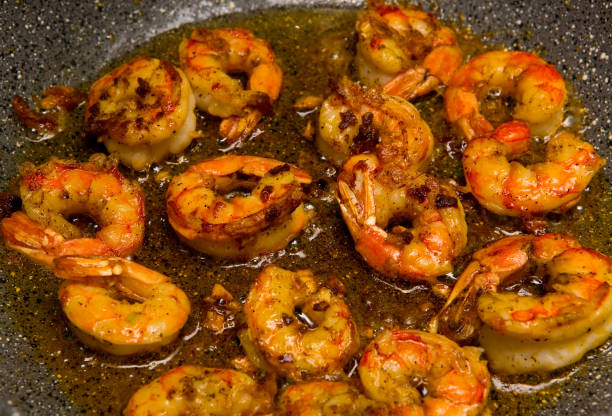 istock Delicious king prawns fried with garlic in a pan. 649197920