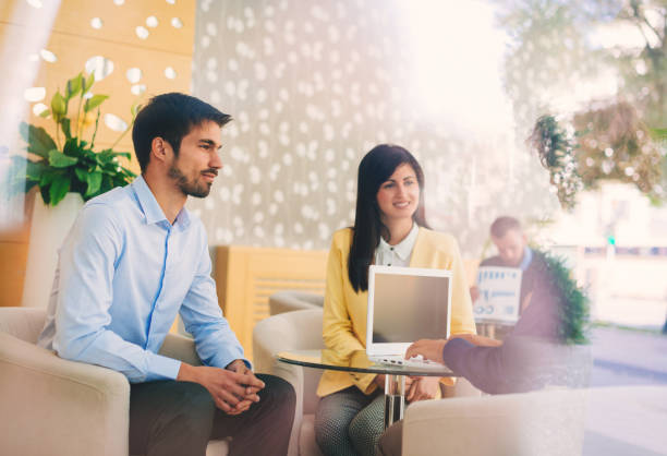 istock Professionals and young business people discussing tasks and finances in modern interior 649198230
