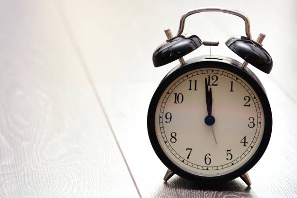 istock Retro bell alarm clock on wooden background 649199314