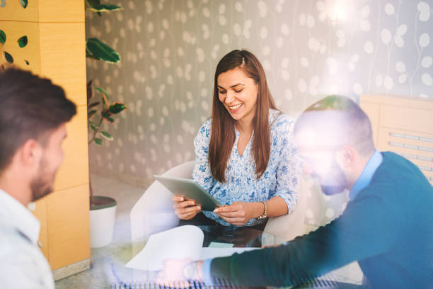 istock Professionals and young business people discussing tasks and finances in modern interior 649206076