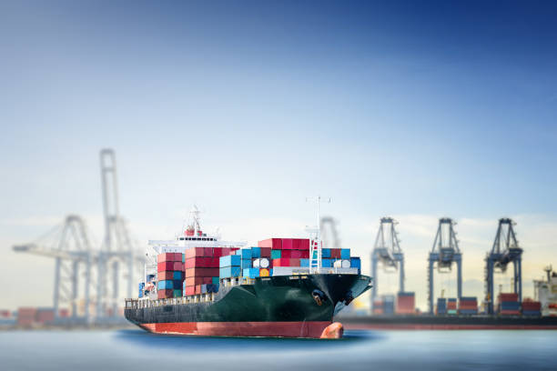 istock Logistics and transportation of International Container Cargo ship in the ocean with working crane bridge in sea port background 649206442