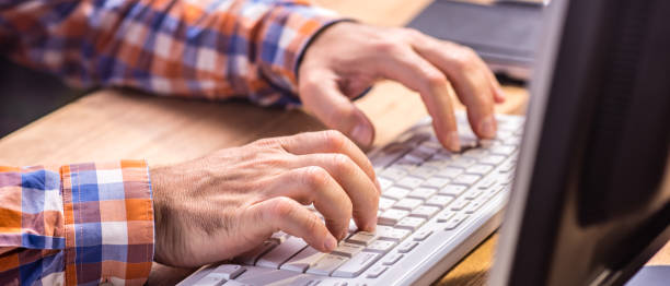 istock Close up of man typing on a computer keyboard 649207592