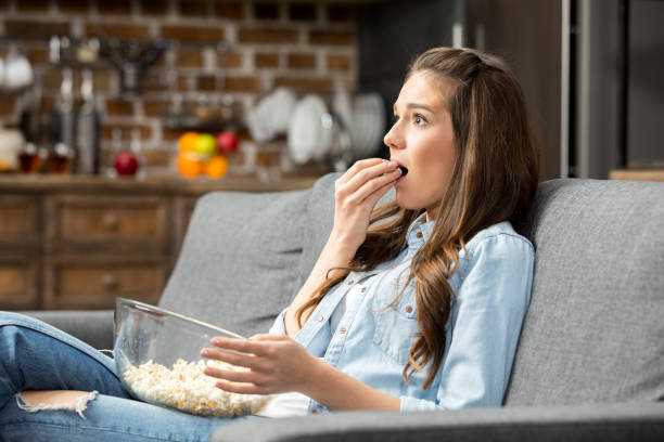 istock Girl eating popcorn 649208286