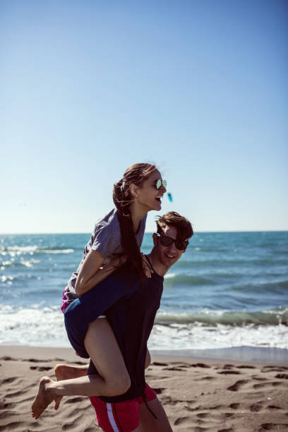 istock Stylish couple having fun on the beach 649211056
