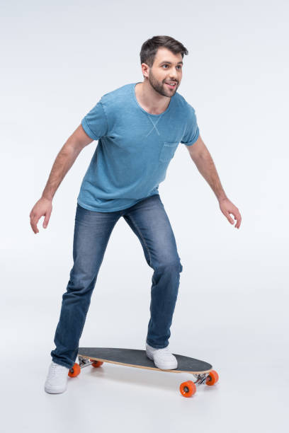 istock side view of man trying to ride skateboard on white 649211542