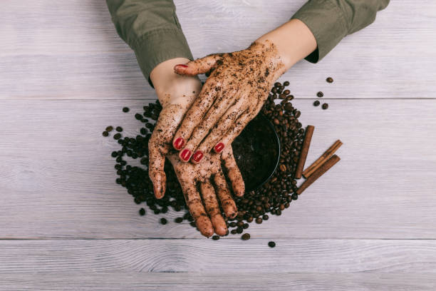istock Female hands rubbing the coffee scrub closeup 649218458