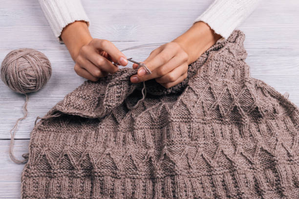 istock Female hands knitting wool sweater 649218496