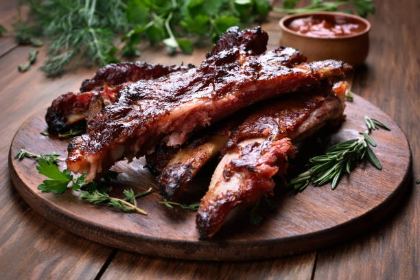 Grilled pork ribs Grilled sliced barbecue pork ribs on wooden board, shallow depth of field barbecue beef stock pictures, royalty-free photos & images