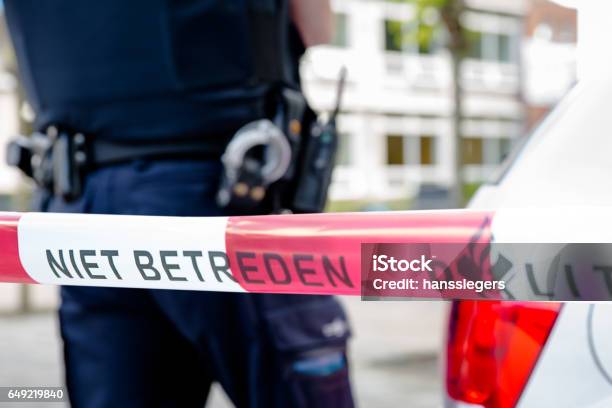 Dutch Policeman Behind Plastic Tape Stock Photo - Download Image Now - Police Force, Netherlands, Arrest