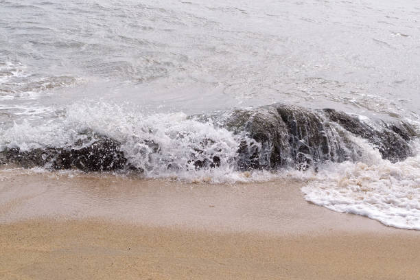 istock Sea water splashing over rocks 649220058