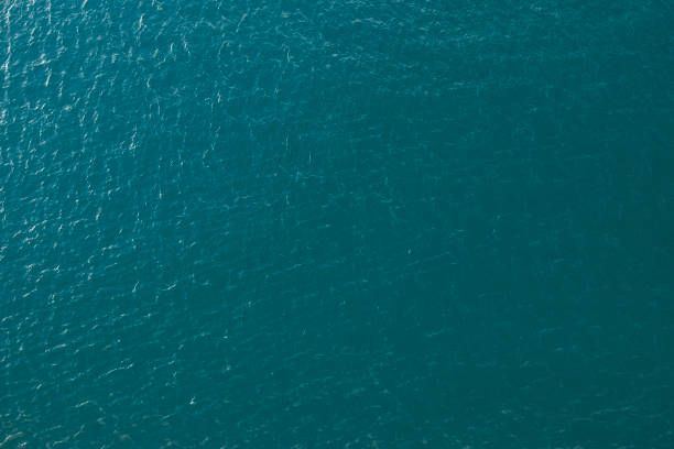 Water texture aerial image Vast blue ocean background with moderate waves looking straight down calm before the storm stock pictures, royalty-free photos & images