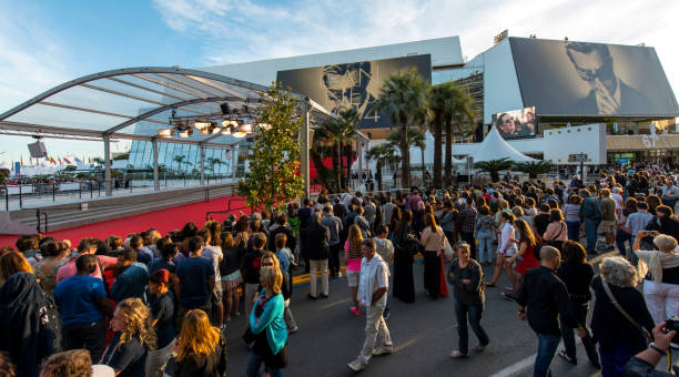 Cannes Film Festival Great Auditorium of the exit door at Cannes in France, the famous red carpeted stairs and crowd of people waiting at the gate output. cannes film festival stock pictures, royalty-free photos & images
