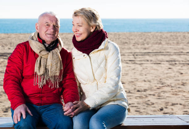 istock Mature couple sitting by sea 649223866
