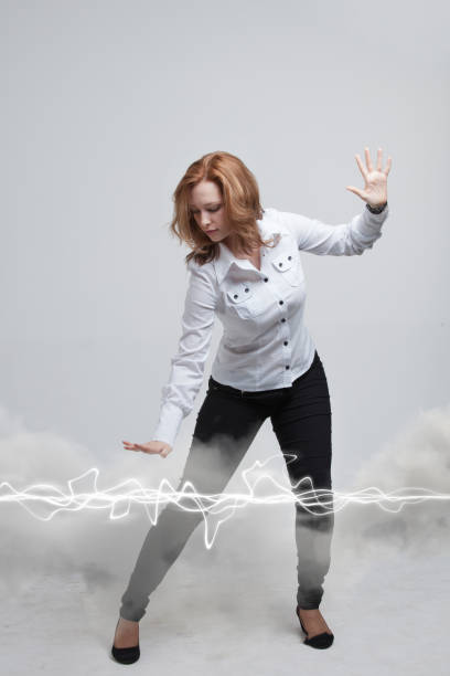 istock Woman making magic effect - flash lightning. The concept of electricity, high energy 649228908