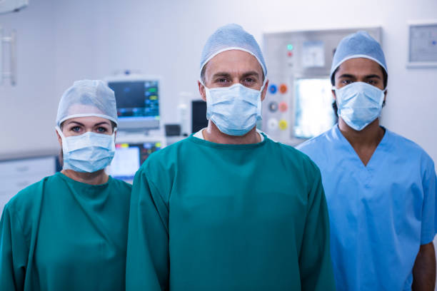 istock Portrait of surgeons standing in operation room 649229734