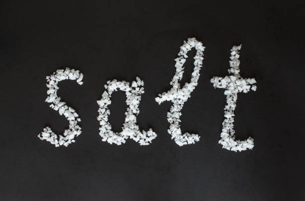 istock Text Salt from a large sea salt on black background. 649232152