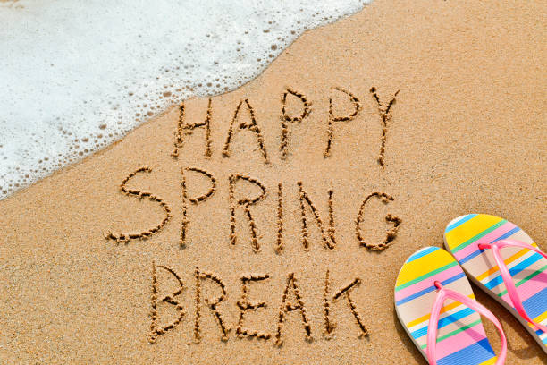text happy spring break in the sand stock photo