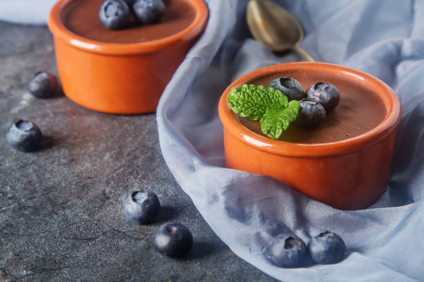 istock Chocolate mousse with berries in a ceramic bowl. Grey dark backg 649236366