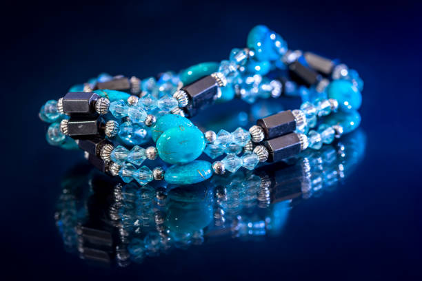 istock bracelet mix precious stones and beads isolated on dark blue. 649239146