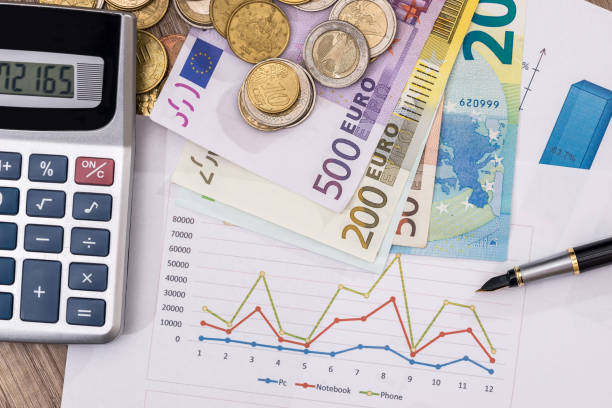 istock Euro notes above business graph, pen and calculator. 649240364