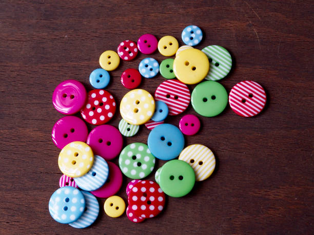 istock Colorful buttons on wood background 649243110
