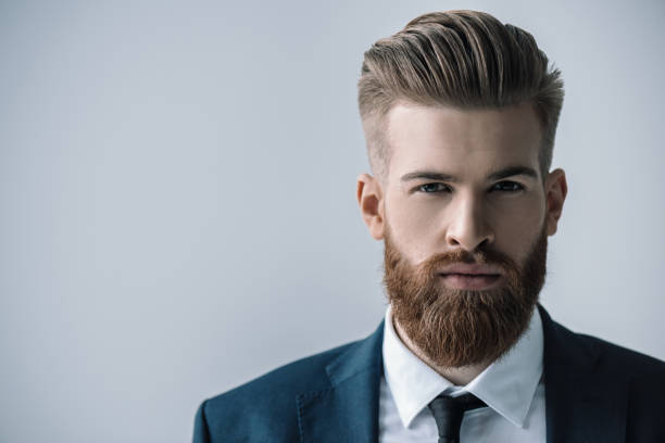 istock Stylish handsome bearded businessman looking at camera 649243186