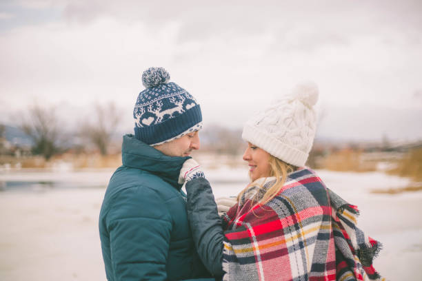 istock Couples holding each other on the shore of lake 649243450