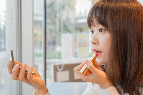 istock Young woman making up in the room 649248372