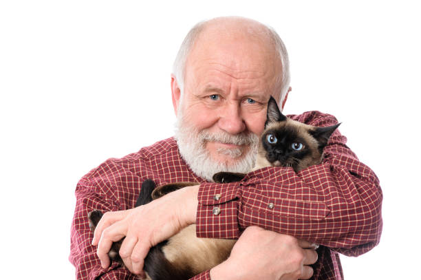 Cheerfull senior man with cat isolated on white