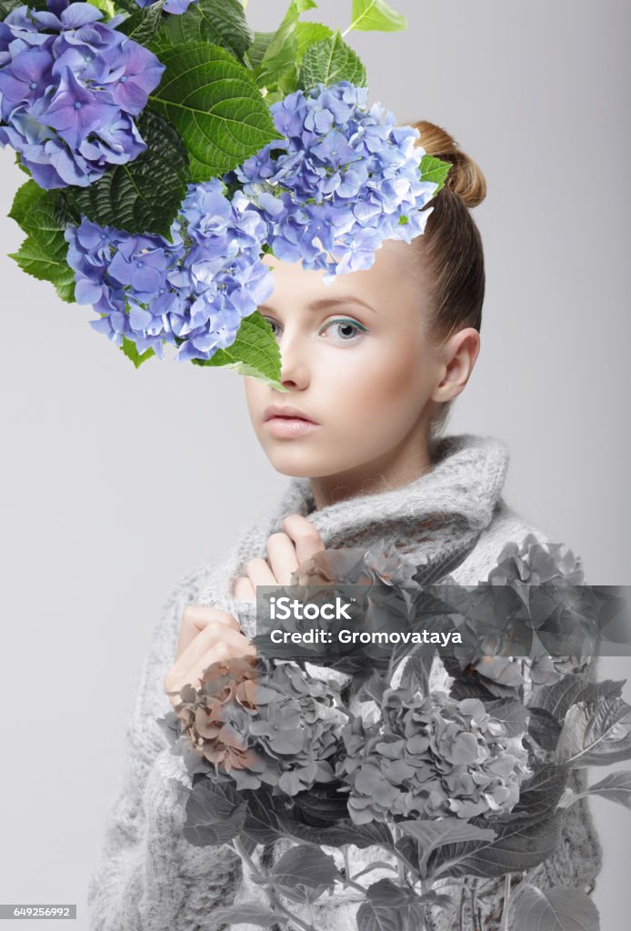 Portrait of a woman. Portrait of girl with flowers in the foreground. Isolated. Abstract Stock Photo