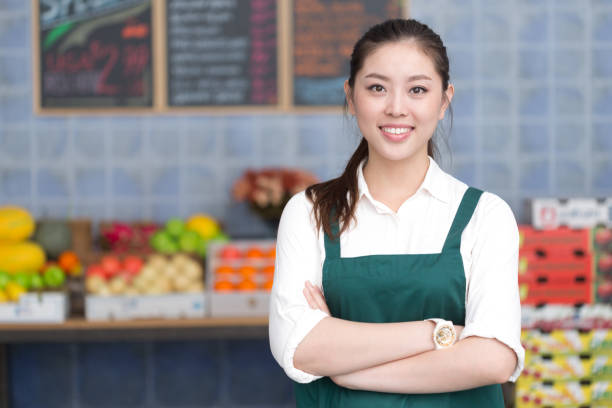 istock young pretty woman works in fruit store 649261992
