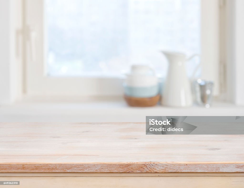 Wooden table top on blurred kitchen window background Kitchen Stock Photo