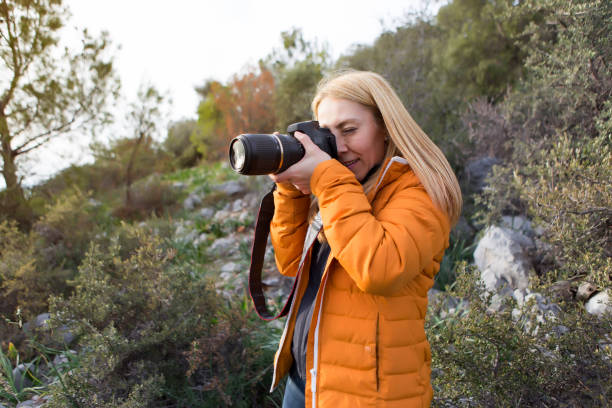 istock Young adult with dslr camera in nature 649267632