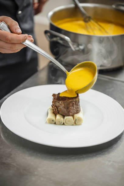 istock Chef pouring gamy sauce 649270630