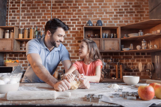 istock Happy father and daughter kneading dough 649270662