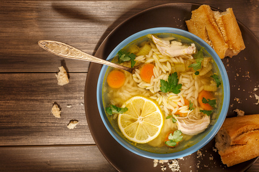 Bowl of Lemon Chicken Orzo Soup Rustic Style